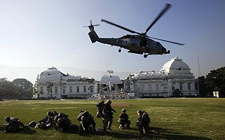 U.S. Navy helicopters touched down on the grounds of Haiti’s damaged presidential palace bringing reinforcements in the struggle for security and earthquake disaster relief.