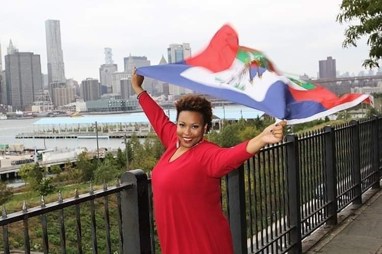 Ella Turenne holding with pride a Haitian flag.