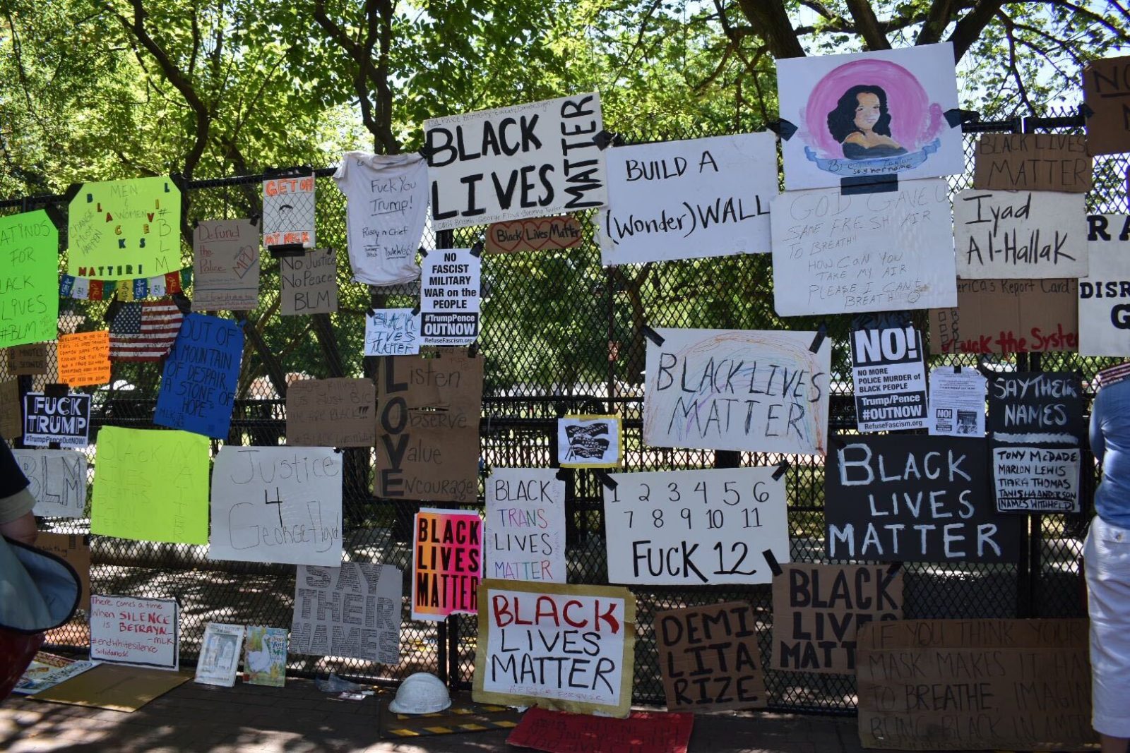 Signs and protest artwork cover the fence outside the White House. —photos by Matt Blitz and Mary Tyler March for the DCist.